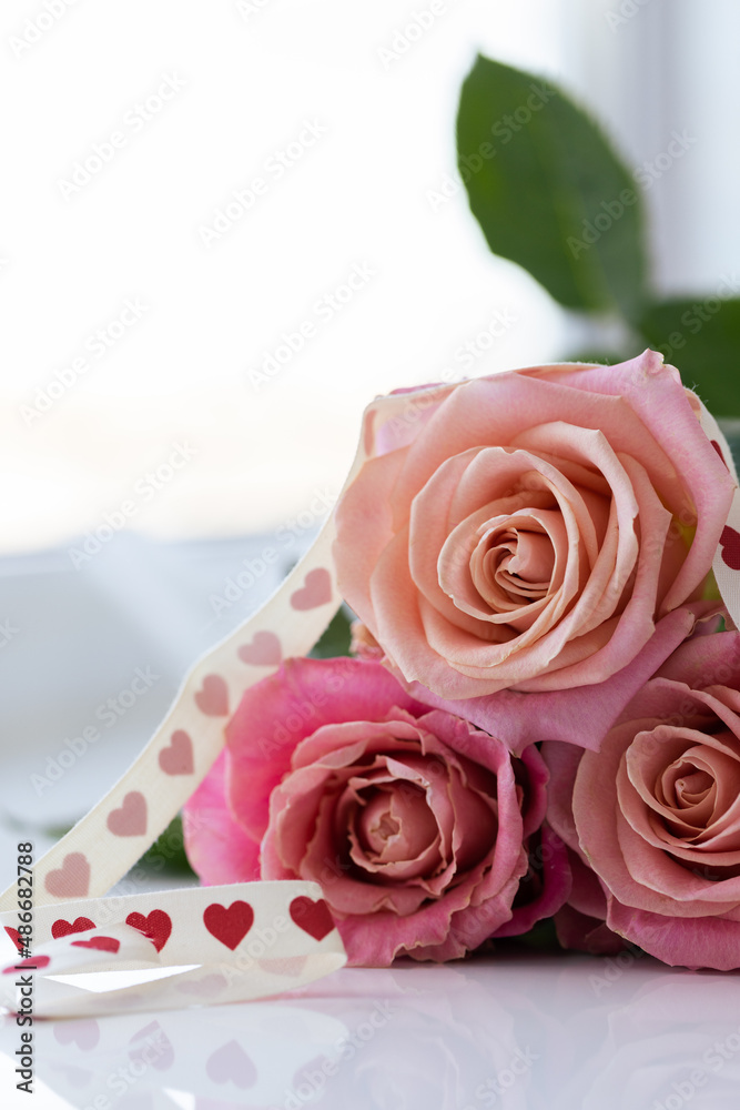 Bouquet of roses with gift ribbon. Closeup. Floral gift. Bouquet of roses with gift ribbon. Closeup. Floral gift.