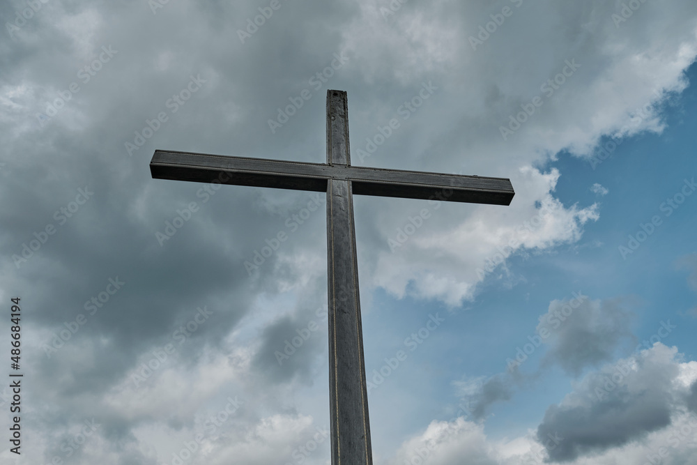 a summit cross can be found on top of a mountain
