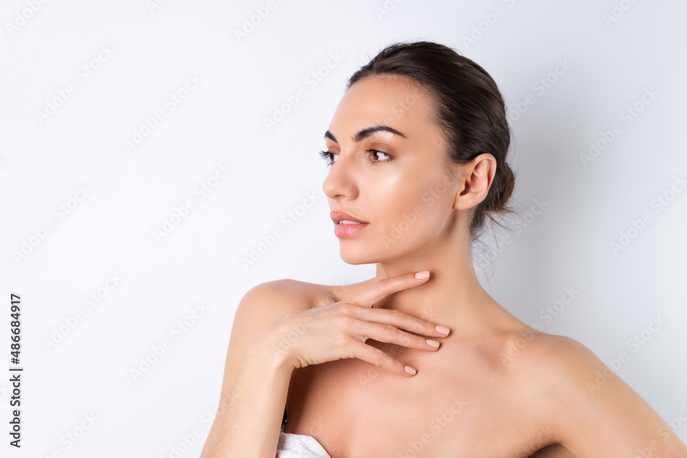Close beauty portrait of a topless woman with perfect skin and natural make-up, plump nude lips, on a white background. Close beauty portrait of a topless woman with perfect skin and natural make-up, plump nude lips, on a white background.