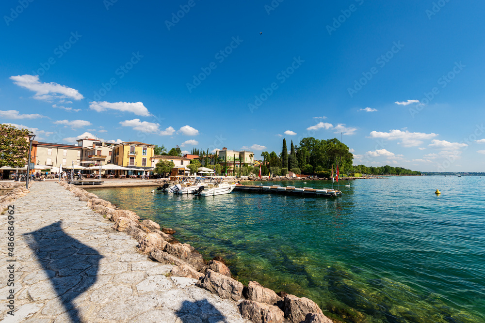 Small port of the village of Cisano with motor boats moored. Tourist resort on the coast of Lake Garda (Lago di Garda). Bardolino municipality, Verona province, Veneto, Italy, southern Europe. 
