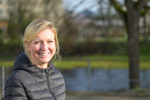 Cute young blond woman with an impish grin