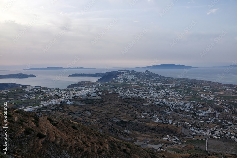 Panoramic view of the island of Santorini while the sun is slowly setting