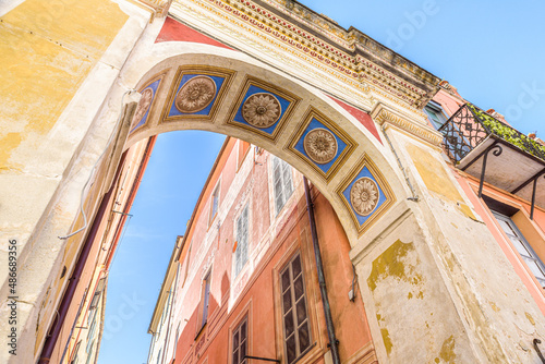 Finalborgo  Finale Ligure  Italy. May 5  2021. View of the arch of Via Torcelli at Piazza Garibaldi with ancient ornamental decorations.