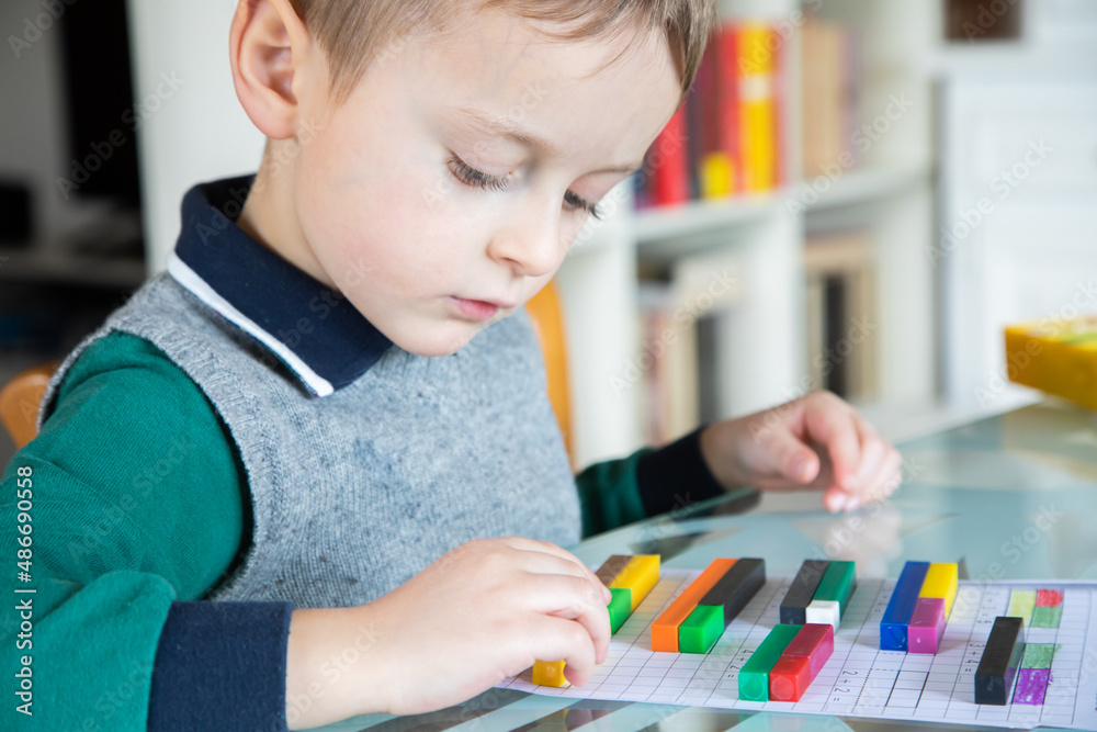 6 years old caucasian boy learning at home mathematics. Elementary age. 6 years old caucasian boy learning at home mathematics. Elementary age.