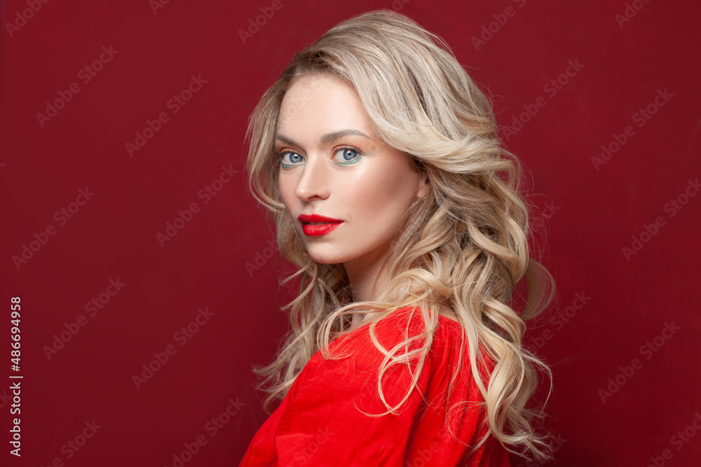 Beauty blonde woman looking at camera on red background
