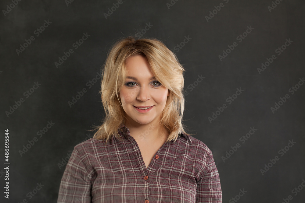 Fototapeta premium Smiling woman on black background