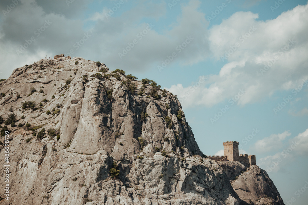 Fototapeta premium Genoese fortress on a rock against a summer blue sky
