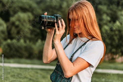 Ginger teen, girl taking photos with camera