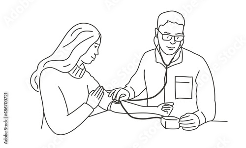 Male doctor in glasses measures blood pressure to young woman.