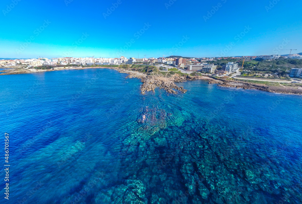 Panoramic view of Alghero rocky shore on a sunny day