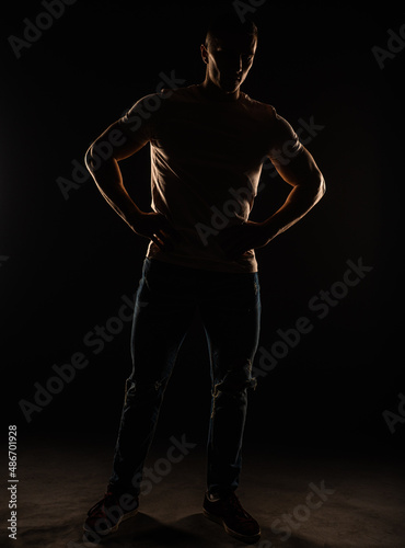 Silhouette of a guy posing in studio
