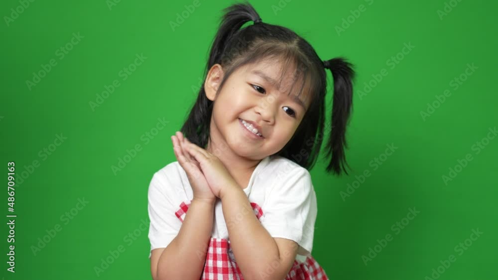 Portrait of happy and funny Asian child girl on green screen background, a child looking at camera. Preschool kid dreaming fill with energy feeling healthy and good concept Portrait of happy and funny Asian child girl on green screen background, a child looking at camera. Preschool kid dreaming fill with energy feeling healthy and good concept