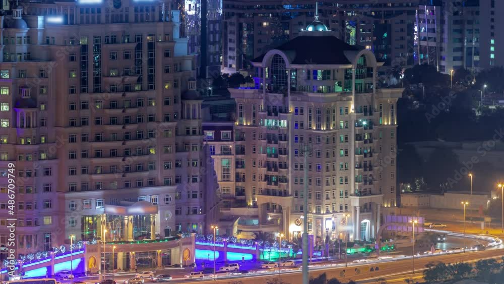 Aerial view to financial district in Dubai with hotels and traffic on the road night timelapse. Aerial view to financial district in Dubai with hotels and traffic on the road night timelapse.