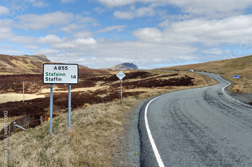 rural road on Isle of Skye with Old Man of Storr in the background, Scotland, UK