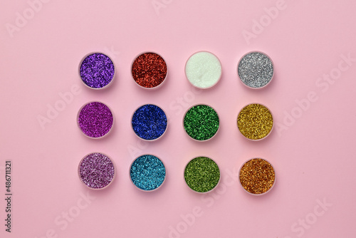 A palette of sequins on a pink background. Glitter. Eye shadow.