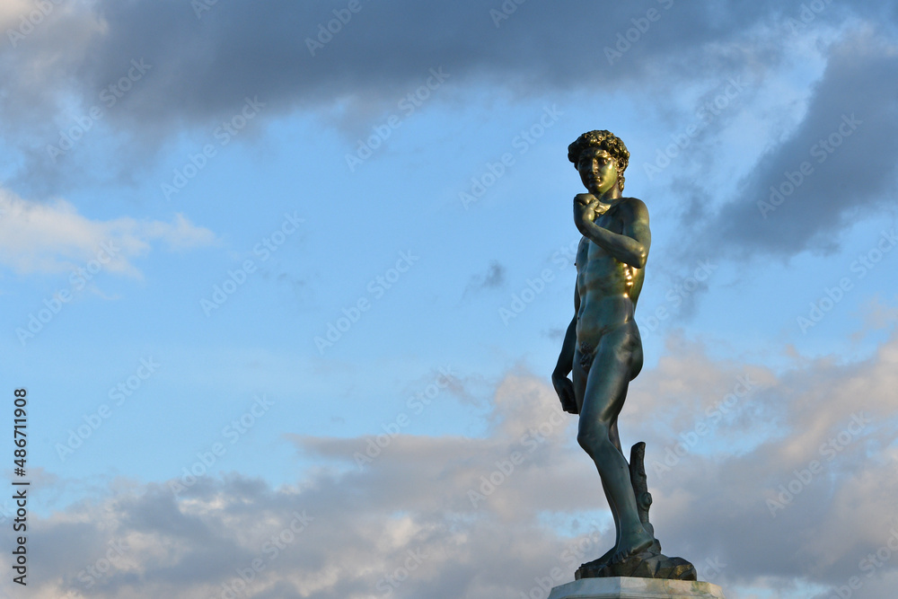 Florence, Michelangelo Square. The Bronze sculpture of Michelangelo's David facing Florence against blue cloudy sky.