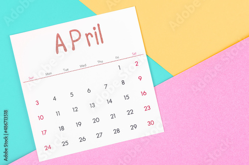 April 2022 calendar on multicolored background.