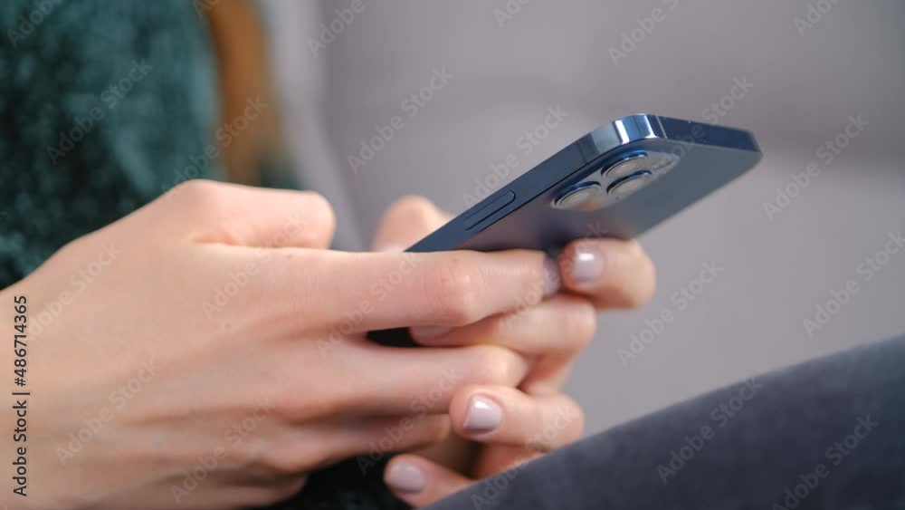 Woman typing message on mobile phone. Young female communicating online with smartphone device. Person using modern cellphone for communication and entertainment during lockdown Woman typing message on mobile phone. Young female communicating online with smartphone device. Person using modern cellphone for communication and entertainment during lockdown