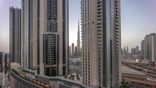 Tallest skyscrapers in downtown dubai located on bouleward street near shopping mall aerial day to night timelapse.