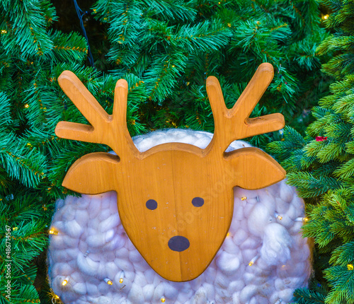 wooden fawn on the background of the Christmas tree