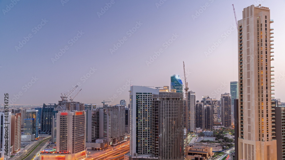 Skyscrapers at the Business Bay in Dubai aerial day to night timelapse, United Arab Emirates