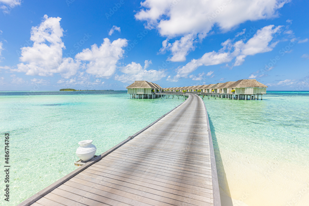 Panoramic travel landscape of Maldives beach. Tropical panorama, luxury water villa resort with wooden pier or jetty, blue sky. Luxury honeymoon destination background, summer holiday and vacation