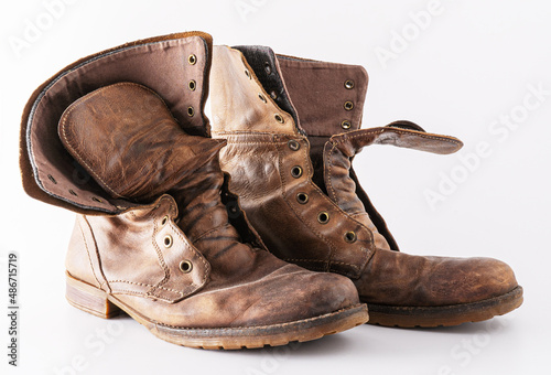 Old shoes on a white background. Leather brown shoe. Worn shoes. Boots.