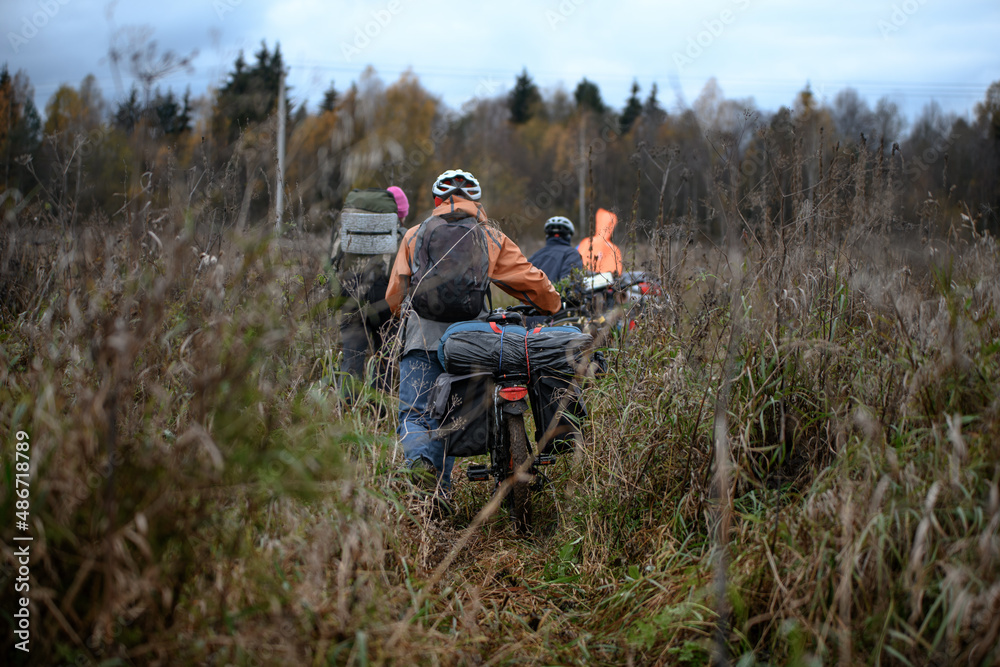 Russian bicyclists in the autumn field, Moscow Region