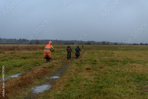 Russian bicyclists in the autumn field, Moscow Region © evdokimari
