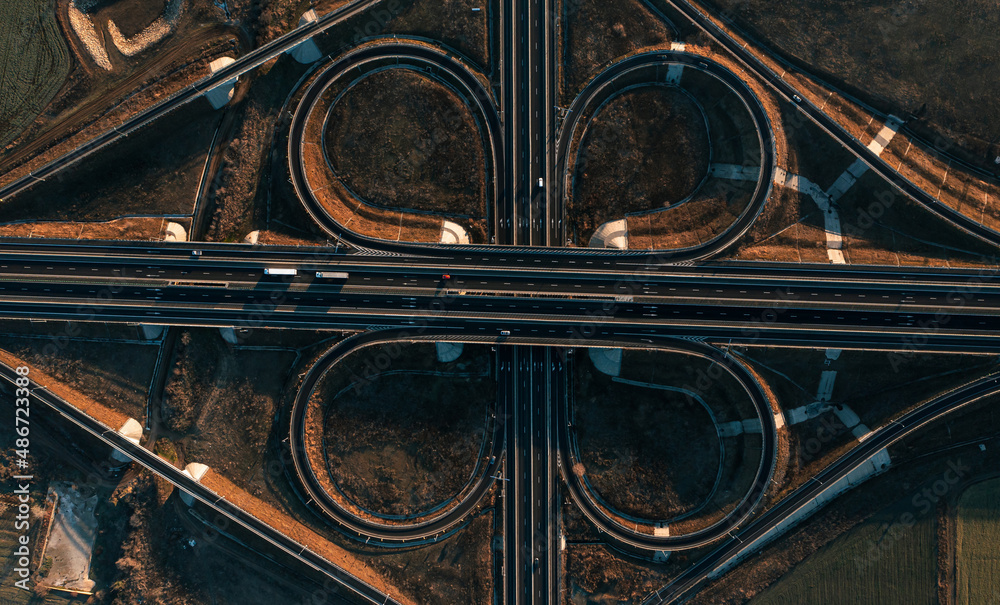 Highway roads infrastructure in Romania. Aerial view of a big cross between A4 motorway and DN3 road next to Constanta city.