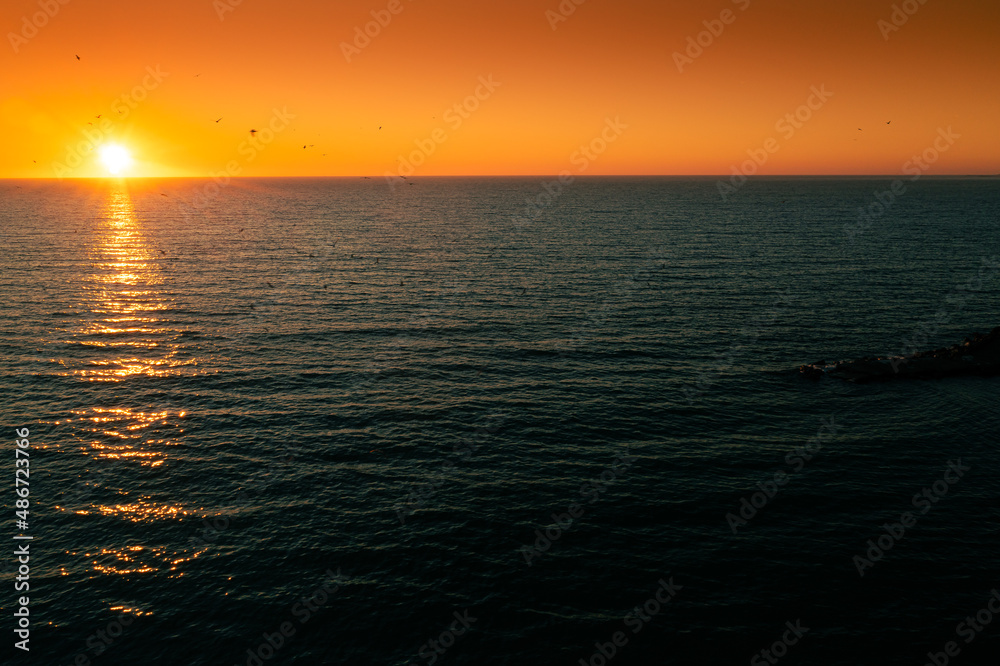 Amazing sunrise at Black Sea shore in Romania, Constanta, with vivid sky color. Wonderful landscape at the seaside.