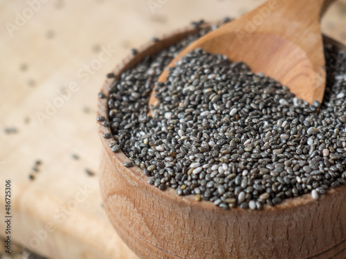 Healthy chia seeds in a wooden spoon on the table close-up
