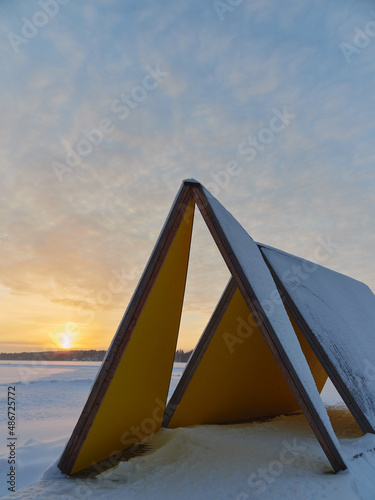 Winter sunset at the Finnish Tuusula lake  modern art and nature of northern Europe  cirrus clouds.