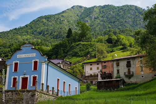 Dordolla village in the Moggio Udinese municipality of Udine province, Friuli-Venezia Giulia, north east Italy. The text on the foreground building indicates that it's a nursery school and play centre photo