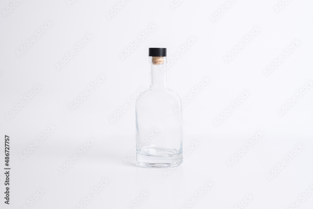 Empty transparent glass bottle with cork screw for drinks and beverage alcohol in blank white isolated background Empty transparent glass bottle with cork screw for drinks and beverage alcohol in blank white isolated background