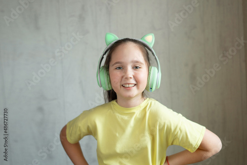 The child girl in wireless bright Modern headphones