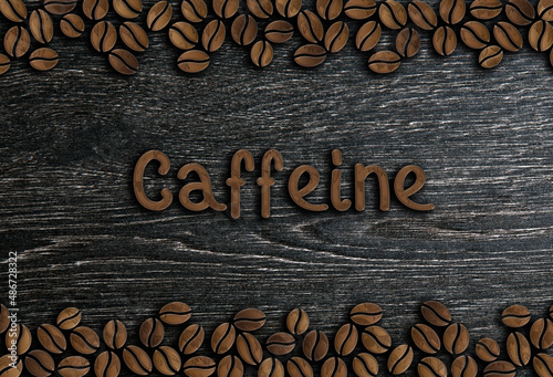 coffee beans ornament with inscription caffeine on a wooden background illustration