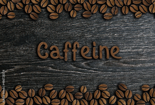 roasted coffee beans with wooden spoon on a wooden background top view