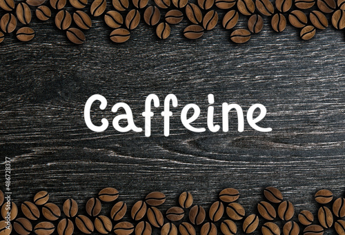 coffee beans ornament with inscription caffeine on a wooden background illustration