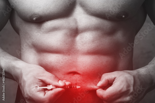 Bodybuilderprepared to make subcutaneous injection in the belly