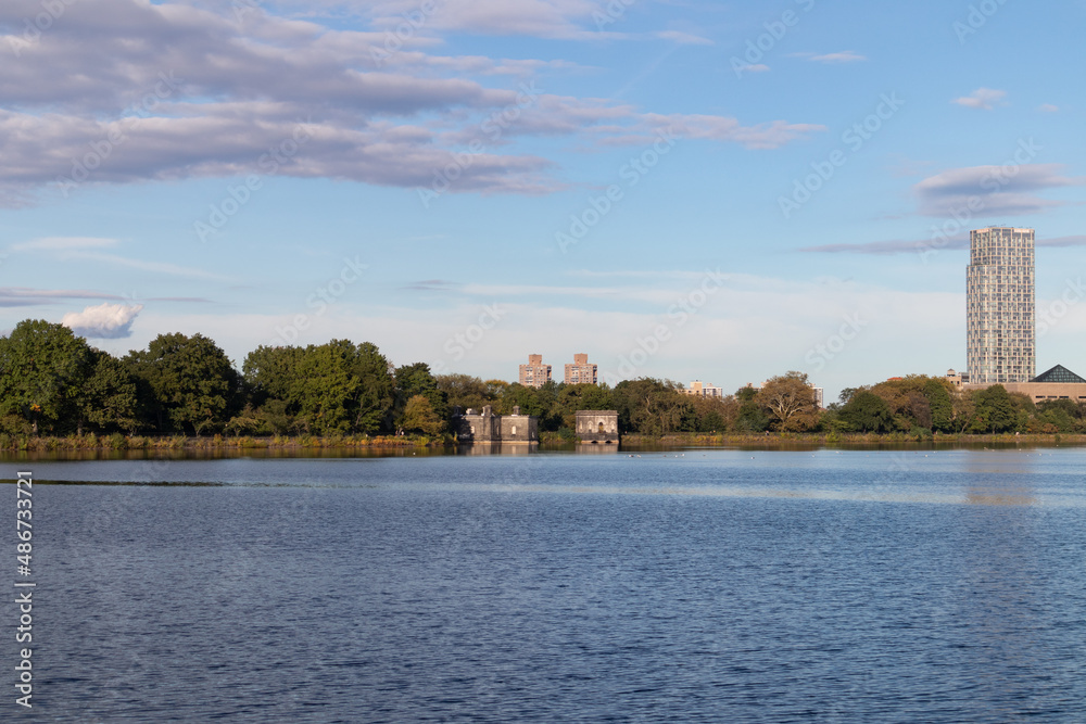 Central Park Reservoir with Green Trees and a Blue Sky in New York City