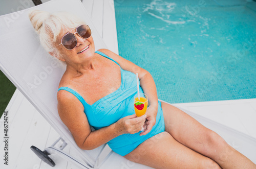 Happy senior woman at the swimming pool photo