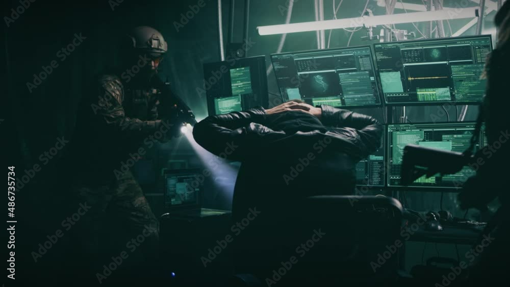 Police tactical unit soldiers with guns arresting cyber criminal during ...