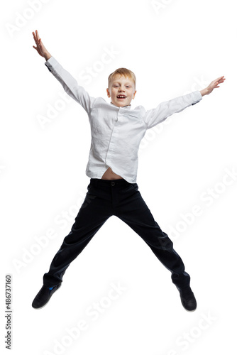 The boy is jumping. A guy in a white shirt and dark trousers. activity and movement. Isolated on white background. Vertical.