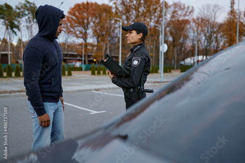 Police woman officer issuing fine to offender