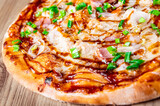 Pizza with chicken, cheese and barbeque sauce. Italian pizza on wooden table background