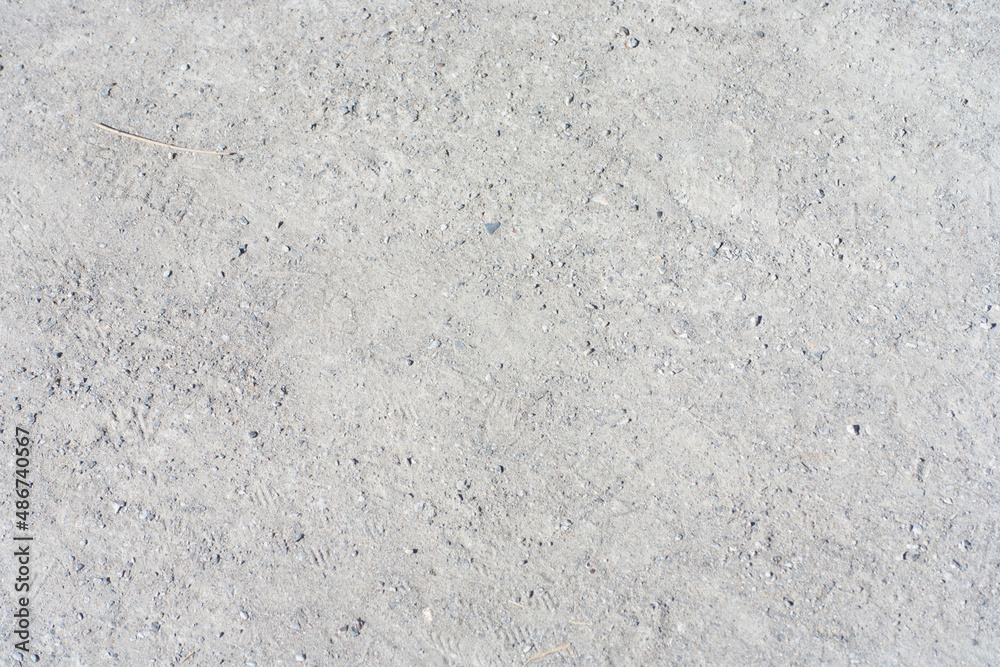 small sand and gravel on path in park at dry sunny summer day