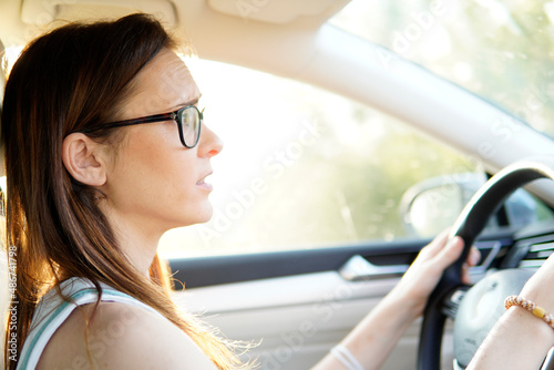 young adult woman driving on a sunny day