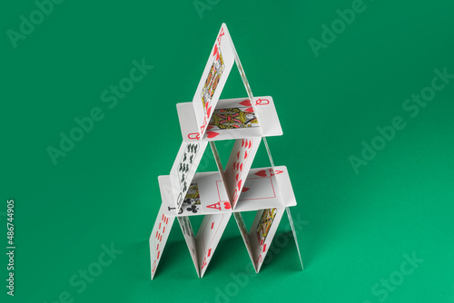Card house made on green casino table