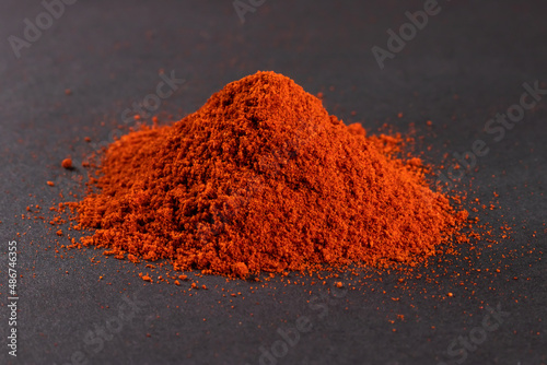 Heap red chili powder on dark background